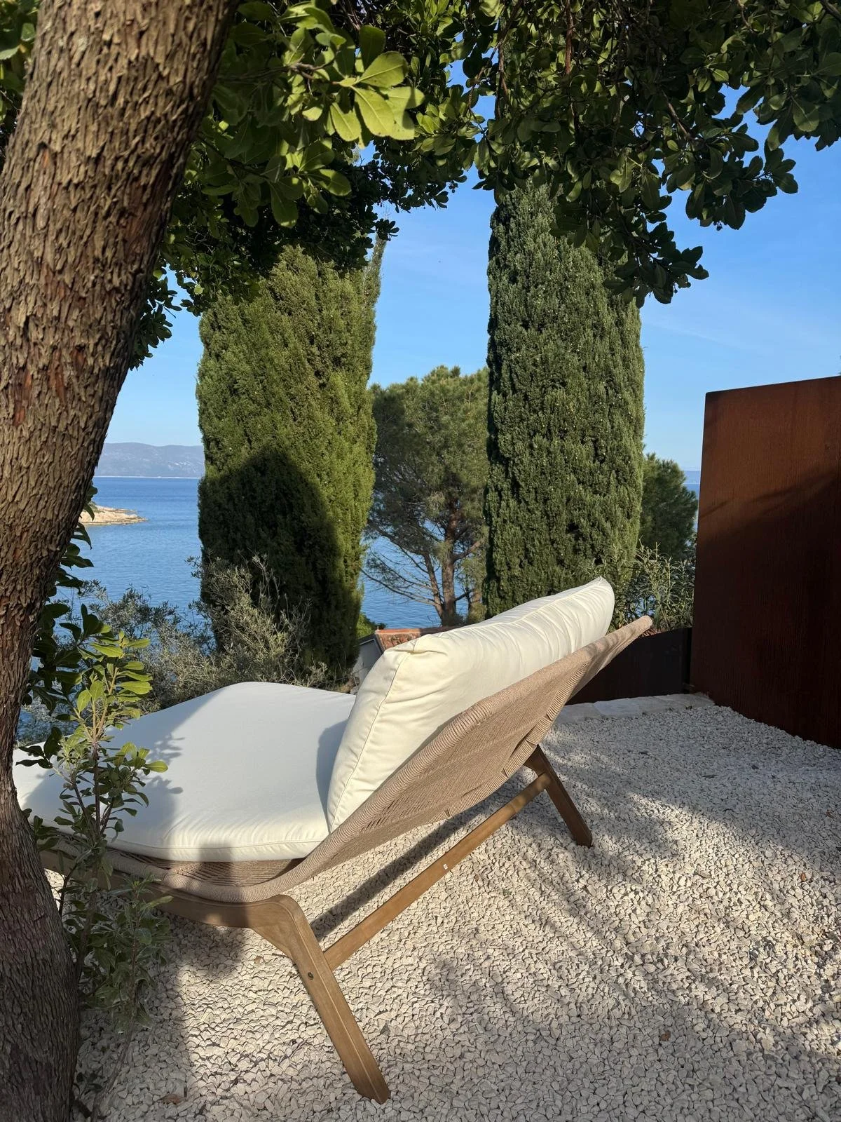 Luxury coastal garden — corten steel terrace with sunlounger and Adriatic sea view
