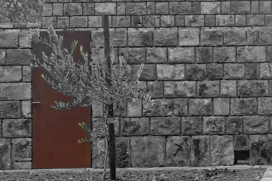 Corten steel door ancient Dalmatian stone village wall