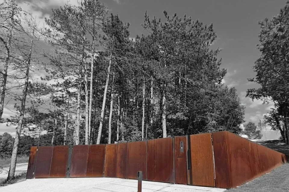 Corten steel entrance gate and fence — pine forest Slovenia